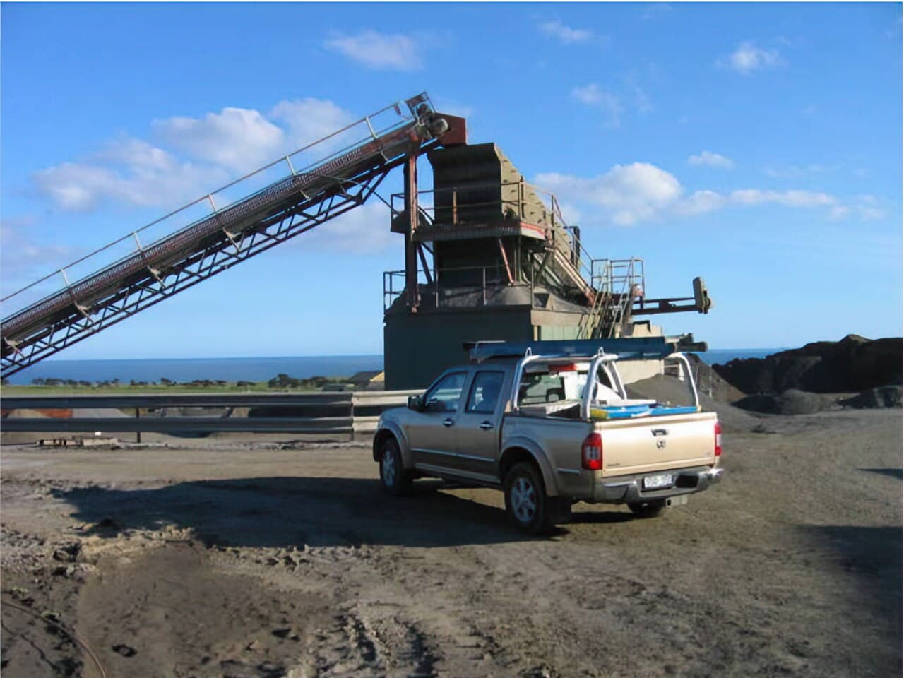 Quarry processing plant with conveyor and screening tower on the Victorian coast